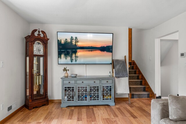 713 9th St NW, Buffalo, MN 55313 - living room with wood finished floors, stairs, and baseboards