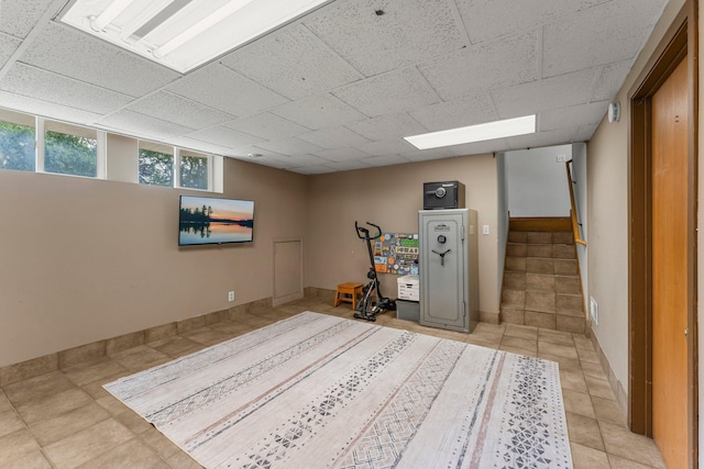 713 9th St NW, Buffalo, MN 55313 - below grade area with stairway, light tile patterned floors, and baseboards