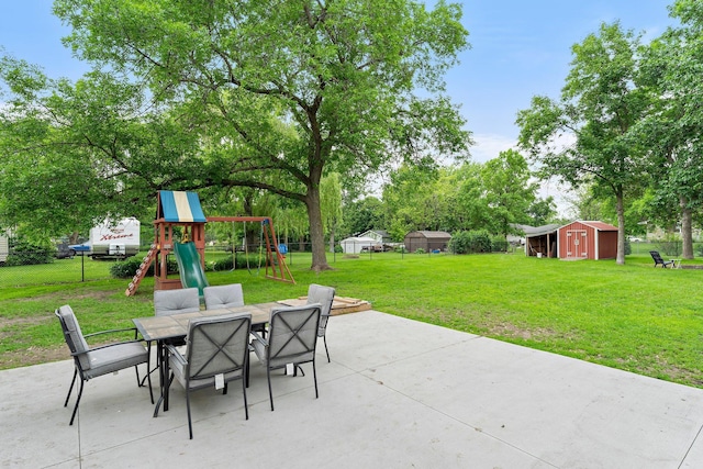 713 9th St NW, Buffalo, MN 55313 - view of patio with outdoor dining space, a playground, and view of scattered trees