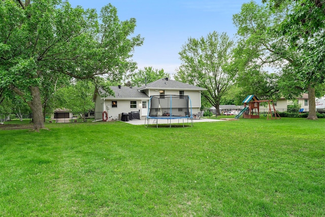 713 9th St NW, Buffalo, MN 55313 - rear view of house with a trampoline and a playground