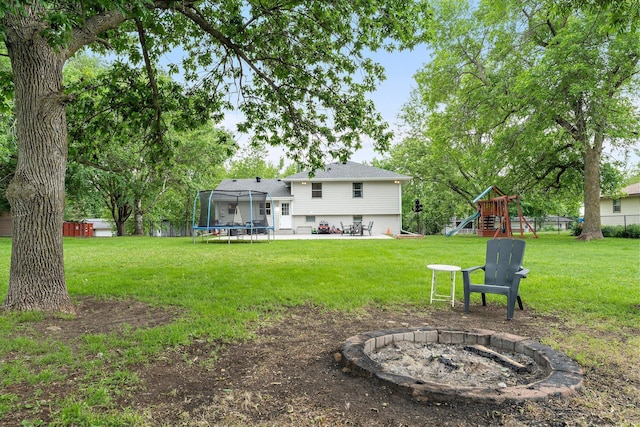 713 9th St NW, Buffalo, MN 55313 - view of yard with a fire pit, a trampoline, a playground, and a patio area