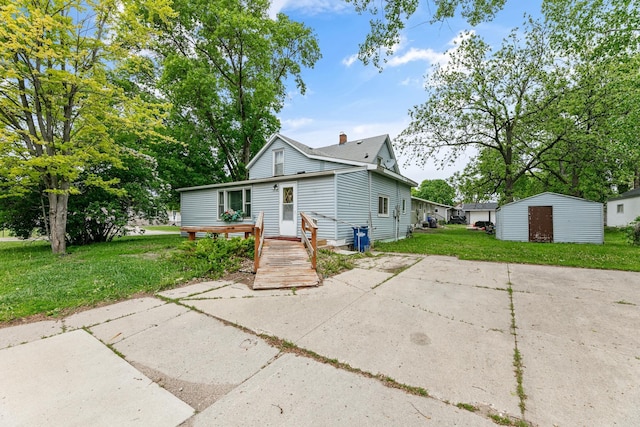 909 14th St S, Benson, MN 56215 - view of front of house featuring a front lawn and a chimney