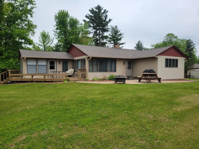 109 155th Ave, Beaver Twp, WI 54889 - back of property with a deck, a lawn, a chimney, a sunroom, and a patio