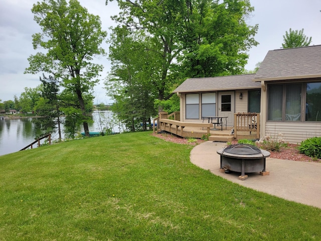 109 155th Ave, Beaver Twp, WI 54889 - view of green lawn featuring an outdoor fire pit, a deck with water view, and a patio