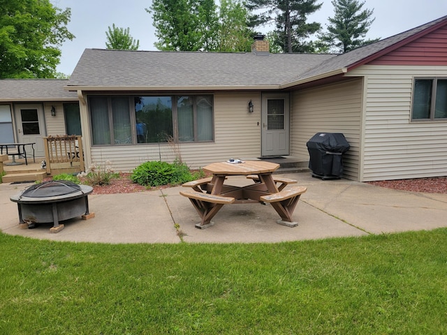 109 155th Ave, Beaver Twp, WI 54889 - rear view of property with an outdoor fire pit, a patio, a chimney, and roof with shingles