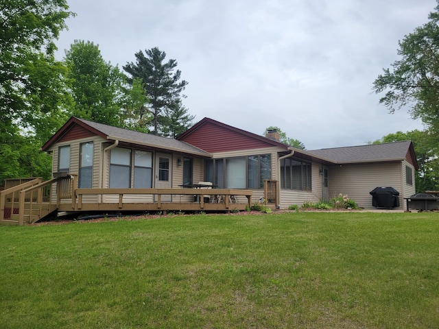 109 155th Ave, Beaver Twp, WI 54889 - back of house with a chimney, a deck, and a lawn