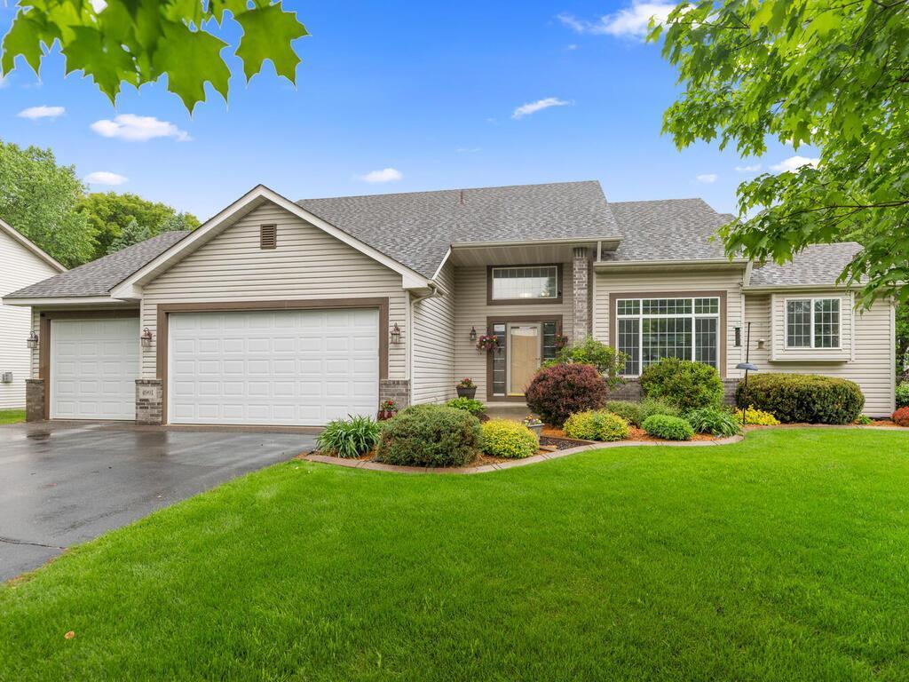 4901 193rd St W, Farmington, MN 55024 - view of front facade with asphalt driveway, a garage, roof with shingles, and a front yard