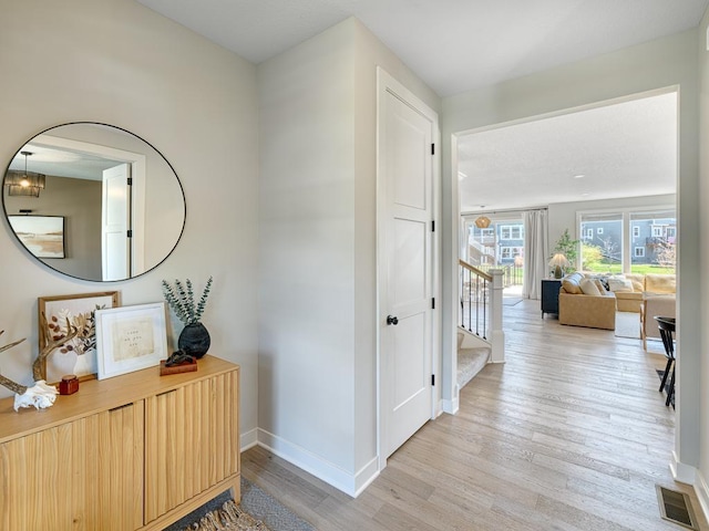 15441 110th Ave N, Dayton, MN 55369 - hallway featuring light wood-style flooring, baseboards, and stairway