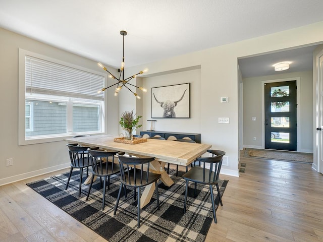 15441 110th Ave N, Dayton, MN 55369 - dining area with a chandelier, light wood-style flooring, and baseboards