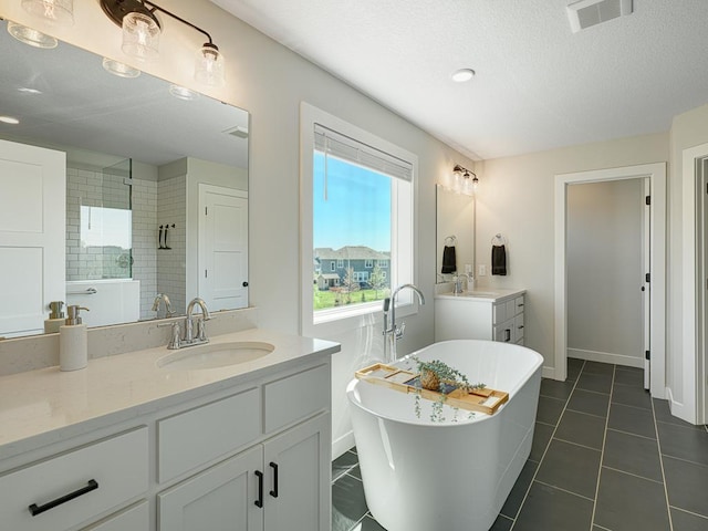 15441 110th Ave N, Dayton, MN 55369 - full bathroom with tiled shower, vanity, a soaking tub, baseboards, and a textured ceiling