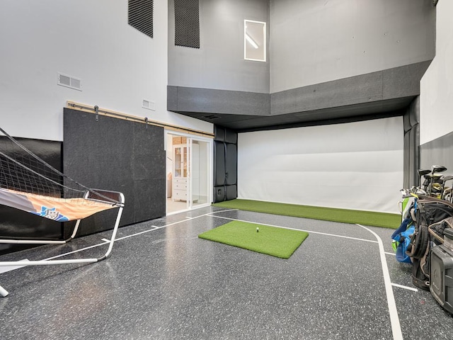 15441 110th Ave N, Dayton, MN 55369 - recreation room with a towering ceiling, speckled floor, and golf simulator