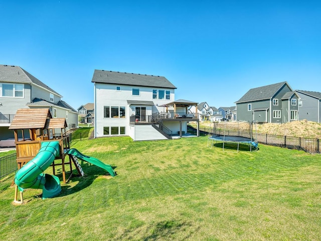 15441 110th Ave N, Dayton, MN 55369 - back of house featuring a trampoline, a residential view, a playground, and stairway
