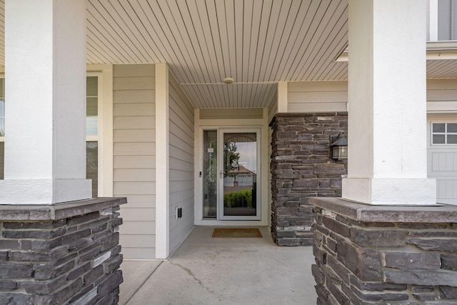 4847 Ashton Curv, Woodbury, MN 55129 - doorway to property featuring covered porch and stone siding