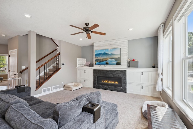 4847 Ashton Curv, Woodbury, MN 55129 - living room with carpet, a ceiling fan, a glass covered fireplace, stairway, and recessed lighting