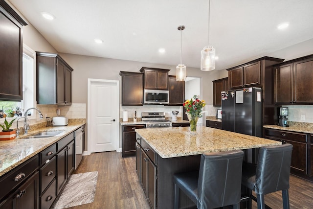 4847 Ashton Curv, Woodbury, MN 55129 - kitchen with stainless steel appliances, a sink, a kitchen island, decorative backsplash, and recessed lighting