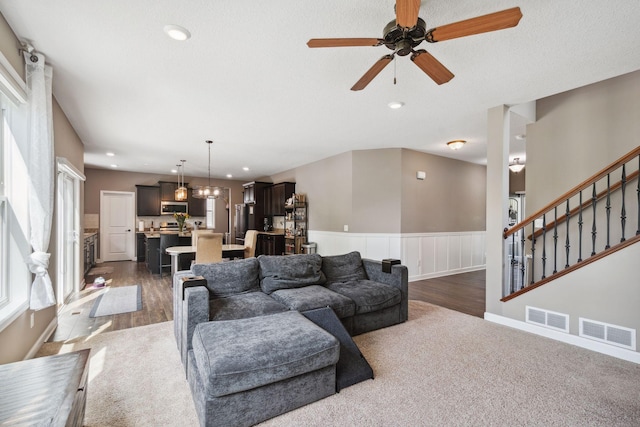 4847 Ashton Curv, Woodbury, MN 55129 - living area featuring dark carpet, a ceiling fan, a wainscoted wall, recessed lighting, and dark wood-style floors