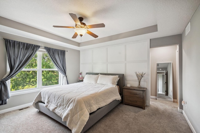 4847 Ashton Curv, Woodbury, MN 55129 - carpeted bedroom featuring a textured ceiling, a raised ceiling, baseboards, and a ceiling fan