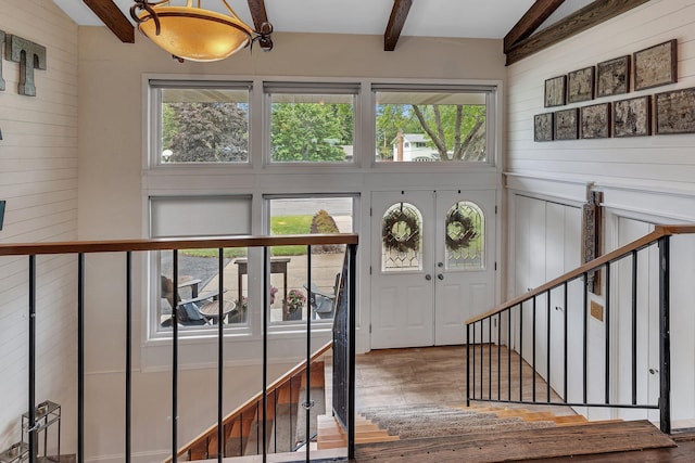 1276 13th Ave N, Saint Cloud, MN 56303 - entryway with wooden walls, beamed ceiling, stairway, wood finished floors, and a high ceiling