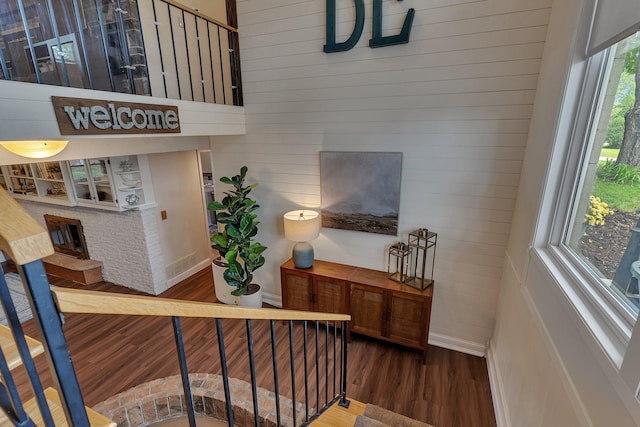 1276 13th Ave N, Saint Cloud, MN 56303 - staircase with wood finished floors, wooden walls, and baseboards