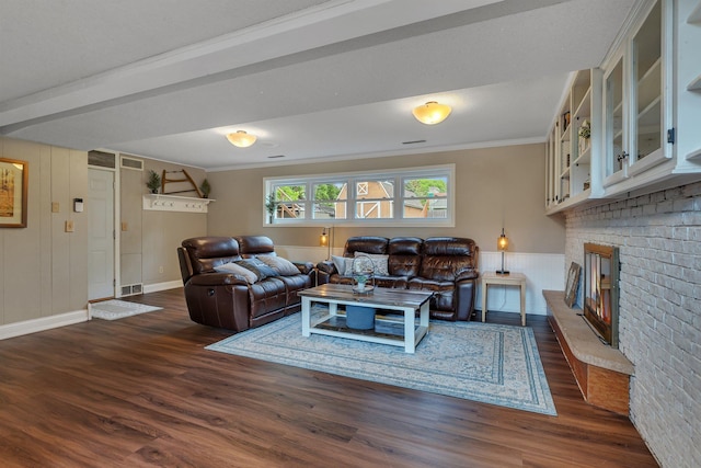1276 13th Ave N, Saint Cloud, MN 56303 - living area with dark wood-style floors, ornamental molding, a brick fireplace, and baseboards