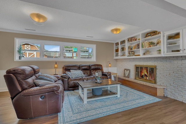 1276 13th Ave N, Saint Cloud, MN 56303 - living area with wood finished floors, ornamental molding, and a brick fireplace
