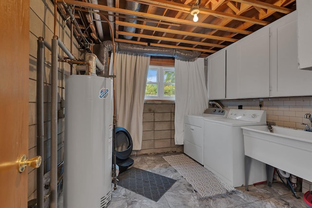 1276 13th Ave N, Saint Cloud, MN 56303 - laundry area featuring gas water heater, washing machine and dryer, and cabinet space