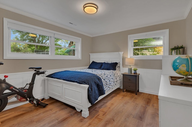 1276 13th Ave N, Saint Cloud, MN 56303 - bedroom featuring ornamental molding, light wood-type flooring, and a wainscoted wall