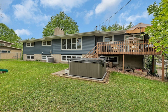1276 13th Ave N, Saint Cloud, MN 56303 - back of property featuring a hot tub, a chimney, a wooden deck, and central AC unit