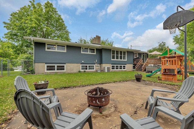 1276 13th Ave N, Saint Cloud, MN 56303 - back of house featuring a fire pit, a playground, a chimney, and a patio