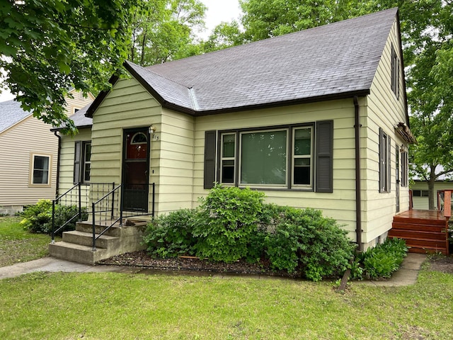 813 11th St N, Benson, MN 56215 - view of front of home with a front yard and a shingled roof