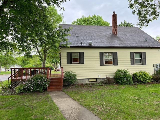 813 11th St N, Benson, MN 56215 - rear view of house featuring a yard, a deck, and a chimney