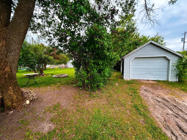 216 Main Ave S, New York Mills, MN 56567 - view of grassy yard with an outdoor structure, a garage, and driveway