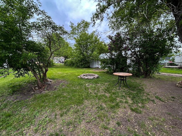 216 Main Ave S, New York Mills, MN 56567 - view of grassy yard with an outdoor fire pit