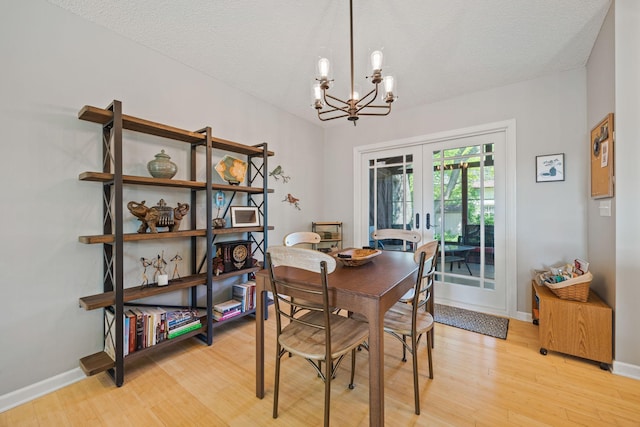 2445 Indian Way N, Saint Paul, MN 55109 - dining room with french doors, a chandelier, light wood-type flooring, baseboards, and a textured ceiling
