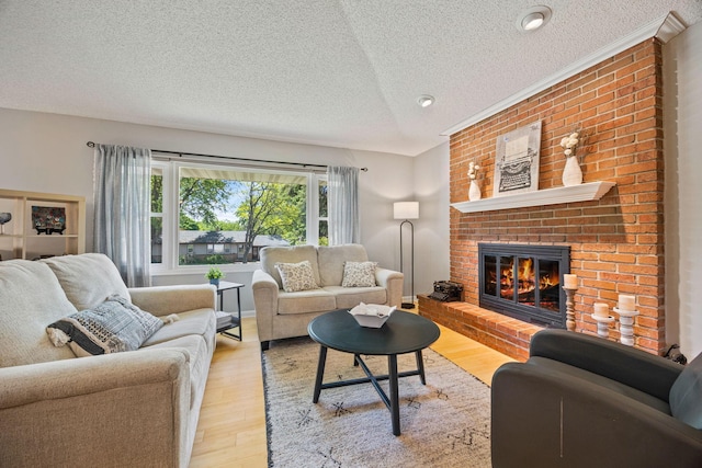 2445 Indian Way N, Saint Paul, MN 55109 - living area featuring a textured ceiling, a brick fireplace, and light wood-style floors