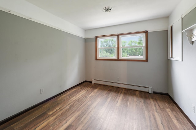 5851 Fairway Ln, Saint Cloud, MN 56303 - empty room with baseboard heating and wood finished floors