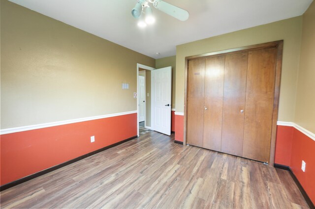 5851 Fairway Ln, Saint Cloud, MN 56303 - unfurnished bedroom with wood finished floors, a closet, and ceiling fan