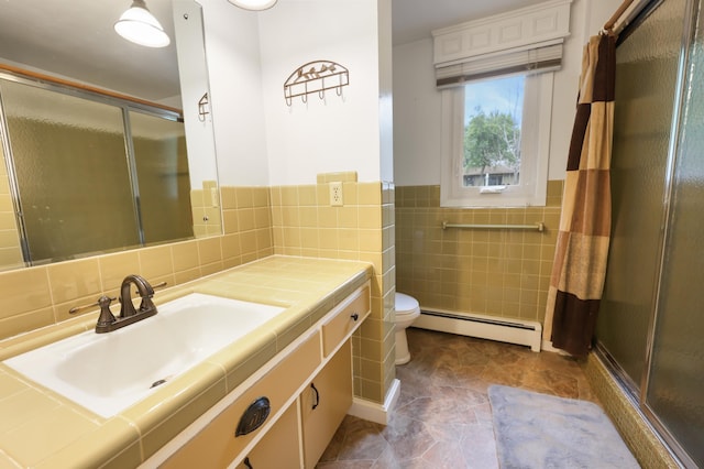 5851 Fairway Ln, Saint Cloud, MN 56303 - full bathroom featuring baseboard heating, a stall shower, vanity, tile walls, and wainscoting