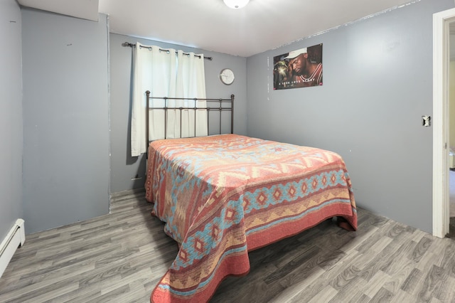 5851 Fairway Ln, Saint Cloud, MN 56303 - bedroom featuring wood finished floors and a baseboard radiator