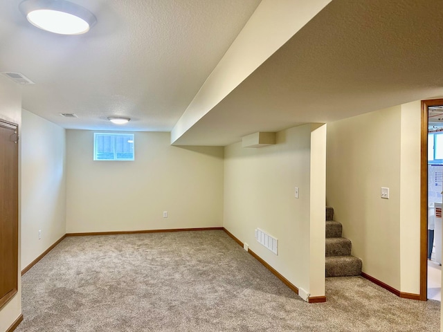 8212 15th Ave S, Bloomington, MN 55425 - basement featuring carpet floors, a textured ceiling, baseboards, and stairway