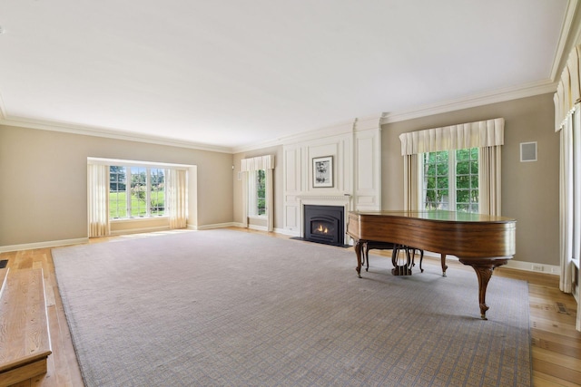1150 Wyndmere Rd, Orono, MN 55391 - living room featuring ornamental molding, a fireplace with flush hearth, light wood finished floors, and baseboards