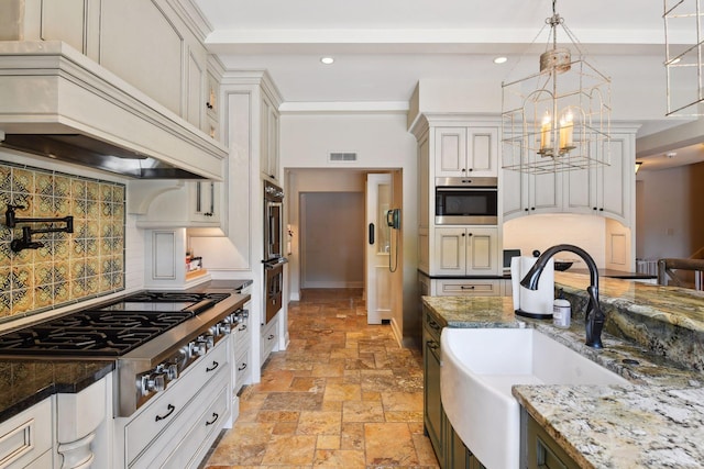 1150 Wyndmere Rd, Orono, MN 55391 - kitchen with custom range hood, a sink, stainless steel appliances, stone tile floors, and a chandelier