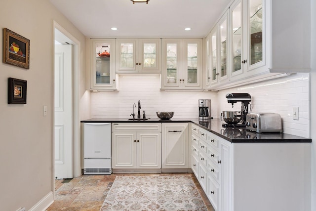 1150 Wyndmere Rd, Orono, MN 55391 - bar area featuring decorative backsplash, a sink, recessed lighting, light stone finish floors, and baseboards