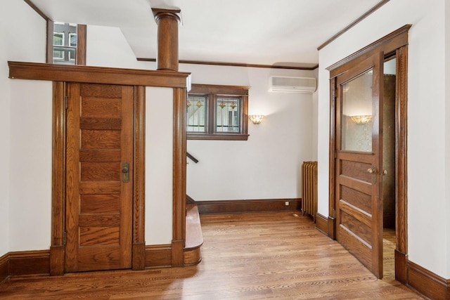 3252 Aldrich Ave S, Minneapolis, MN 55408 - corridor with a wall mounted AC, wood finished floors, radiator heating unit, and baseboards