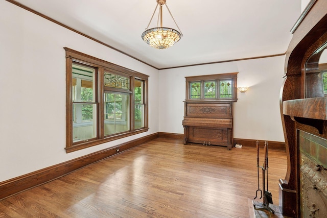 3252 Aldrich Ave S, Minneapolis, MN 55408 - living room with baseboards, wood finished floors, a chandelier, and ornamental molding
