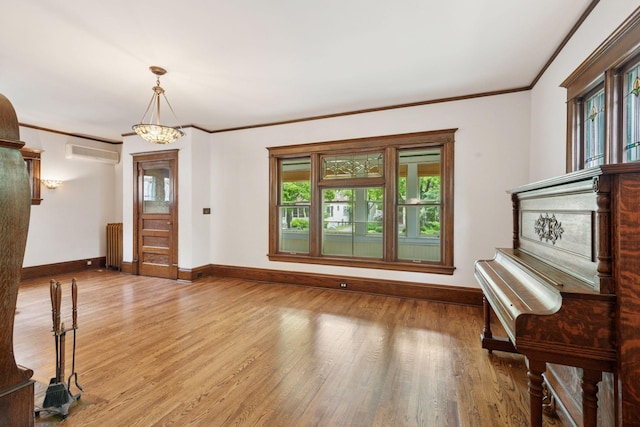 3252 Aldrich Ave S, Minneapolis, MN 55408 - interior space featuring a wall mounted AC, baseboards, radiator, plenty of natural light, and ornamental molding