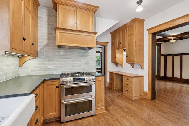 3252 Aldrich Ave S, Minneapolis, MN 55408 - kitchen featuring range with two ovens, light wood finished floors, tasteful backsplash, and dark countertops