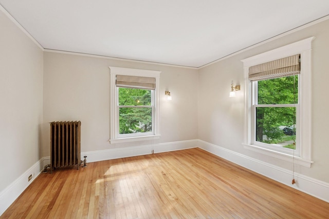 3252 Aldrich Ave S, Minneapolis, MN 55408 - spare room with radiator heating unit, light wood-style floors, healthy amount of natural light, crown molding, and baseboards