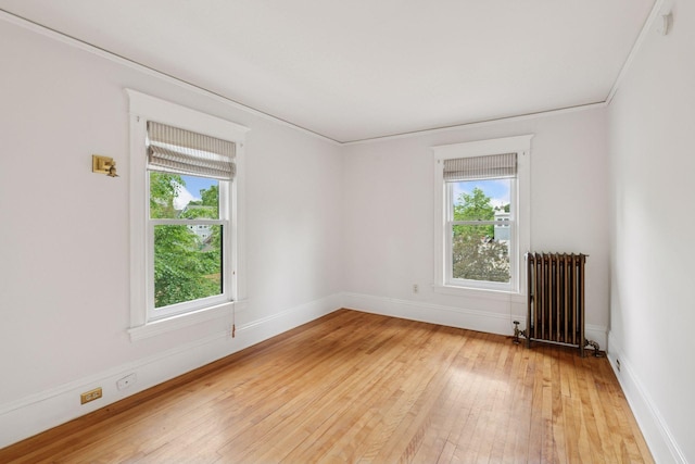 3252 Aldrich Ave S, Minneapolis, MN 55408 - unfurnished room featuring radiator heating unit, healthy amount of natural light, light wood-type flooring, and baseboards