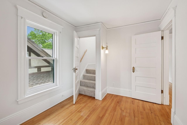 3252 Aldrich Ave S, Minneapolis, MN 55408 - empty room featuring light wood-style flooring, stairway, baseboards, and a smoke detector